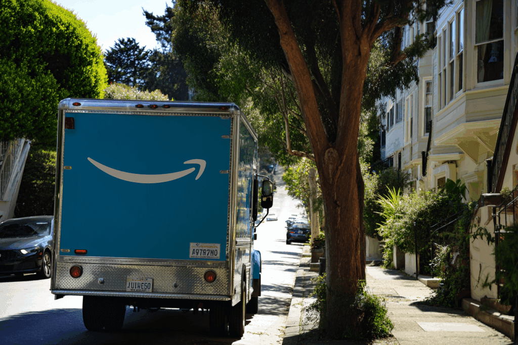An Amazon delivery truck driving down a residential street