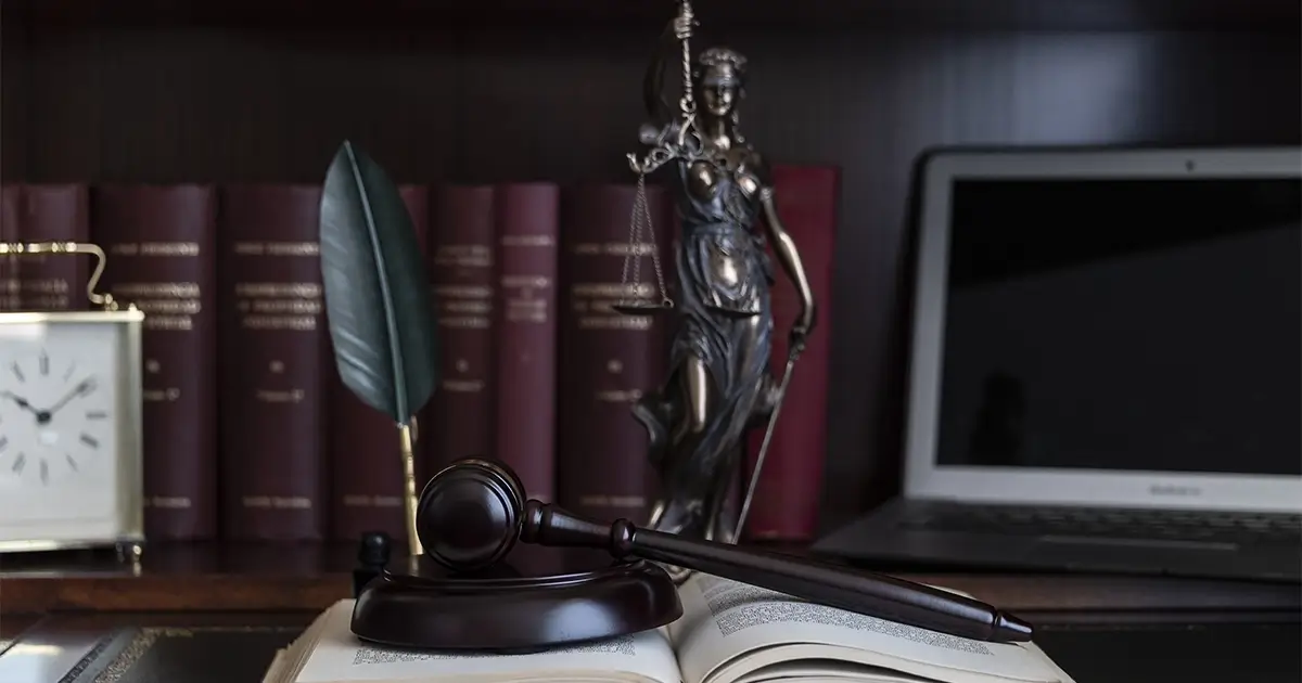 gavel and lady justice in front of law books